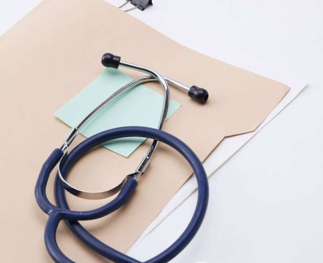 Close up of doctors medical stethoscope and patient medical information.
